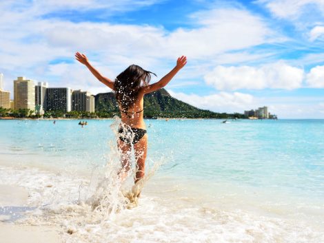 Waikiki beach fun - happy woman on Hawaii vacation
