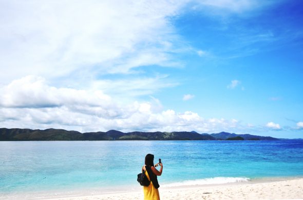 a girl taking pictures on the beach