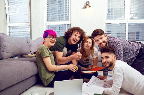 A group of young people students are discussed indoors.