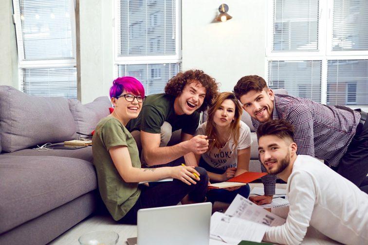 A group of young people students are discussed indoors.