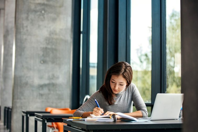 Asian student studying in library