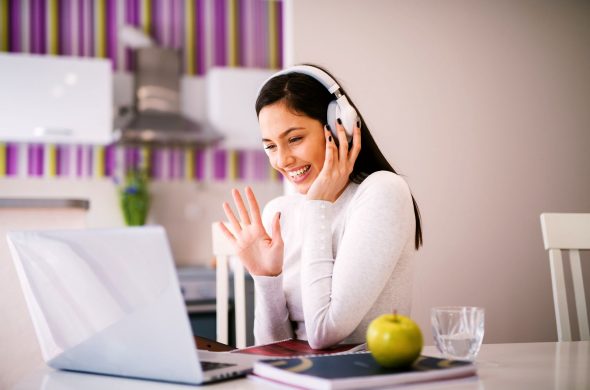 she is studying with online while having her headset on.