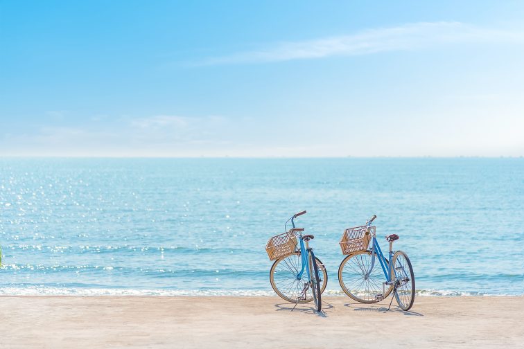 Two,Bicycle,At,The,Beach,On,Blue,Sky