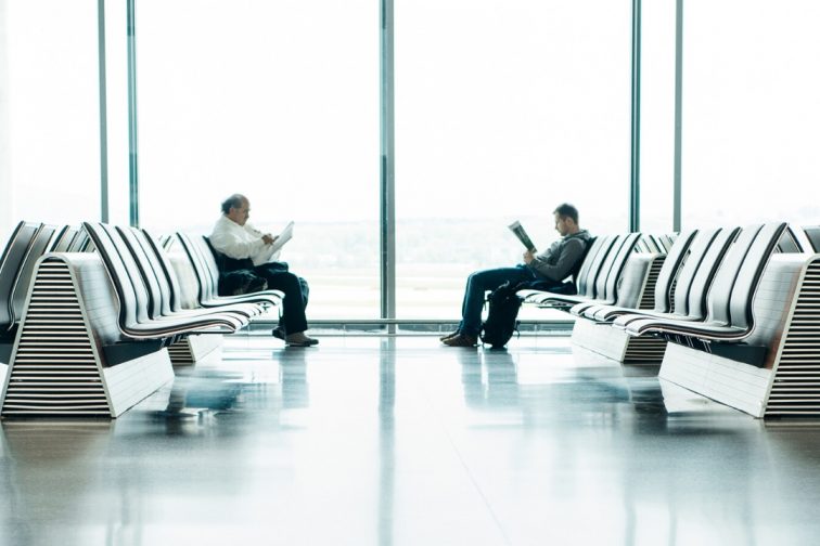 airport 2 people seating at the bench